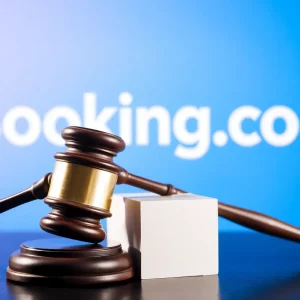 Gavel hitting block with Booking.com logo in background