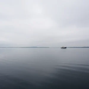 A calm waterway with a fishing boat, symbolizing loss and hope.